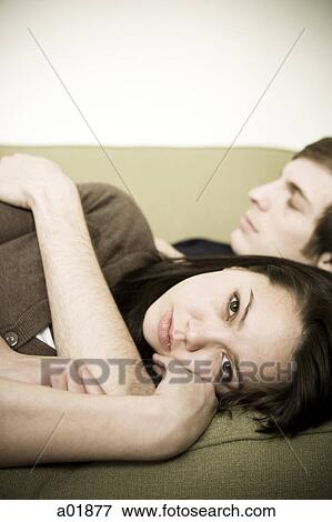 young couple on couch View Large Photo Image Stock Photo - young couple on couch. Fotosearch