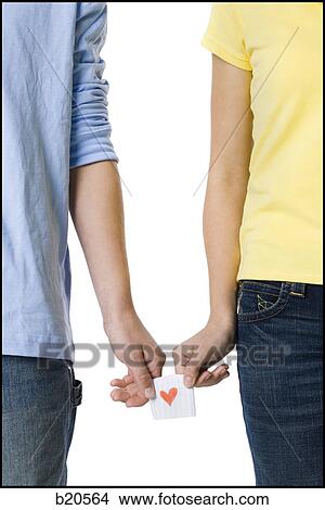 Picture - young couple passing a note. Fotosearch