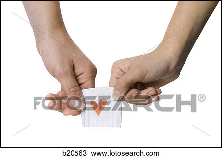 Stock Image - young couple passing a note. Fotosearch