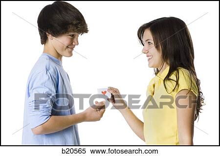 young couple passing a note View Large Photo Image Stock Photography - young couple passing a note. Fotosearch