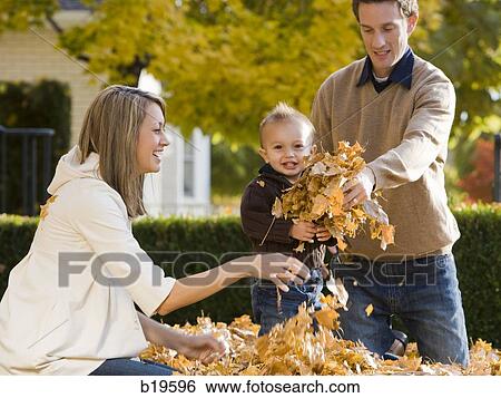 young family playing in leaves View Large Photo Image Stock Photograph - young family playing in leaves. Fotosearch