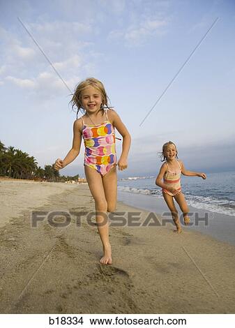 Young girl playing in the surf. View Large Photo Image Picture - Young girl playing in the surf.. Fotosearch
