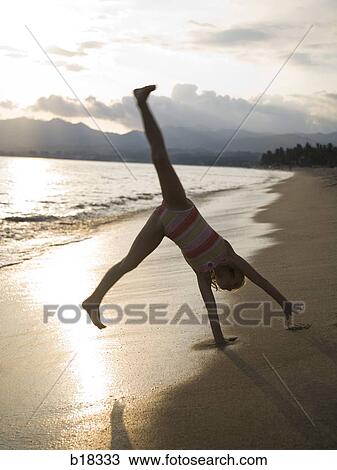 Young girl playing in the surf. View Large Photo Image Stock Image - Young girl playing in the surf.. Fotosearch