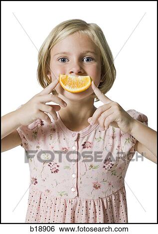 Young girl with an orange smile. View Large Photo Image Stock Photograph - Young girl with an orange smile.. Fotosearch