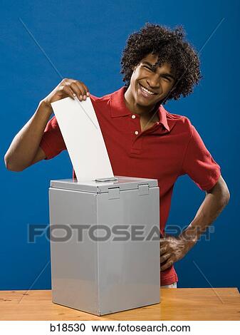 young man casting a ballot. View Large Photo Image Stock Image - young man casting a ballot.. Fotosearch
