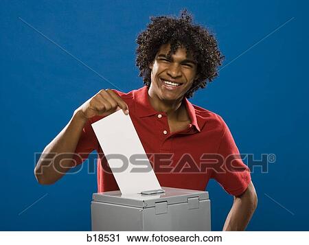 young man casting a ballot. View Large Photo Image Stock Image - young man casting a ballot.. Fotosearch