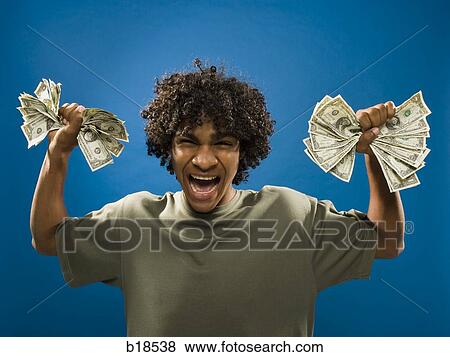 young man holding money. View Large Photo Image Stock Photo - young man holding money.. Fotosearch