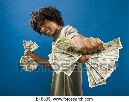 young man holding money. View Large Photo Image Stock Photo - young man holding money.. Fotosearch