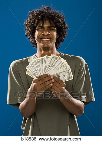 young man holding money. View Large Photo Image Stock Photograph - young man holding money.. Fotosearch