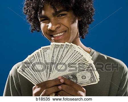 young man holding money. View Large Photo Image Stock Photography - young man holding money.. Fotosearch
