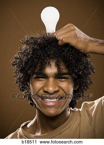 young man in a brown shirt holding light bulbs. View Large Photo Image Stock Image - young man in a brown shirt holding light bulbs.. Fotosearch