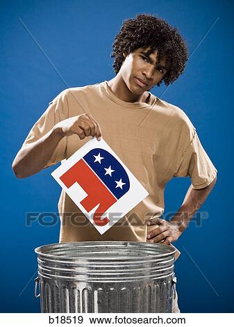 young man in a brown shirt throwing away a political party symbol. View Large Photo Image Stock Photo - young man in a brown shirt throwing away a political party symbol.. Fotosearch