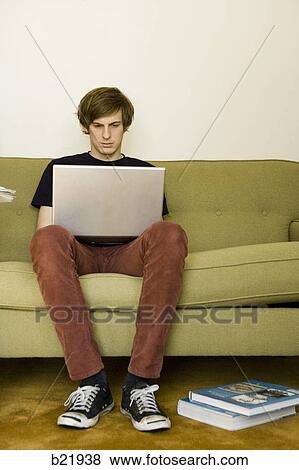 young man in living room View Large Photo Image Stock Photo - young man in living room. Fotosearch