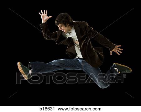 Young man jumping in the air. View Large Photo Image Stock Image - Young man jumping in the air.. Fotosearch