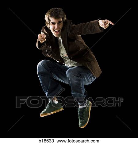Young man jumping in the air. View Large Photo Image Stock Image - Young man jumping in the air.. Fotosearch