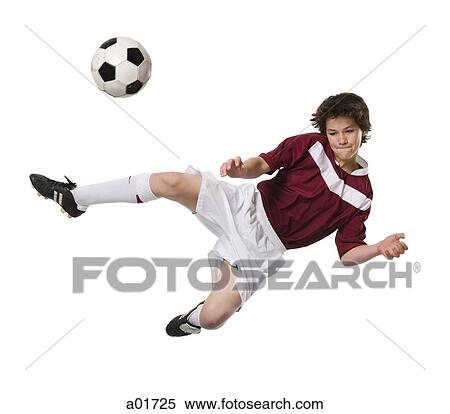 Young man kicking a soccer ball. View Large Photo Image Stock Photography - Young man kicking a soccer ball.. Fotosearch