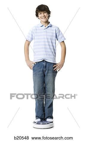 young man stainding on a scale View Large Photo Image Stock Photo - young man stainding on a scale. Fotosearch