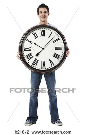 young man with a clock View Large Photo Image Stock Image - young man with a clock. Fotosearch