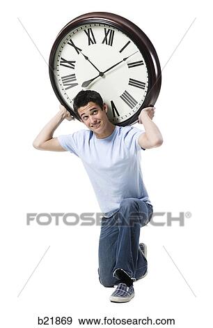 young man with a clock View Large Photo Image Stock Photo - young man with a clock. Fotosearch
