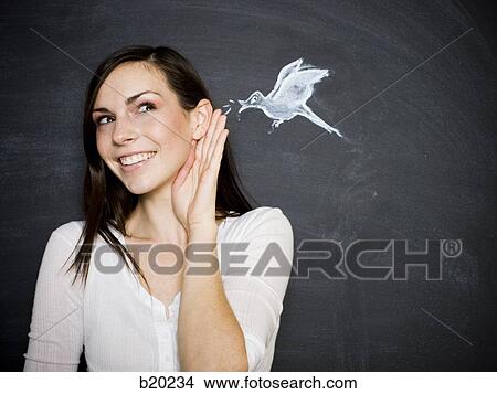 young woman against a chalkboard View Large Photo Image Picture - young woman against a chalkboard. Fotosearch