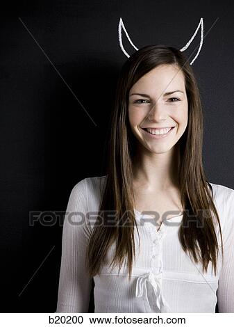 Stock Image - young woman against a chalkboard. Fotosearch