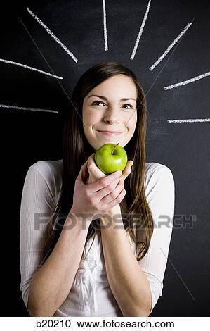 young woman against a chalkboard View Large Photo Image Stock Image - young woman against a chalkboard. Fotosearch