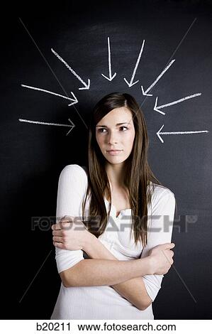 young woman against a chalkboard View Large Photo Image Stock Image - young woman against a chalkboard. Fotosearch