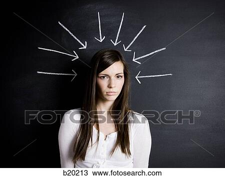 Stock Image - young woman against a chalkboard. Fotosearch