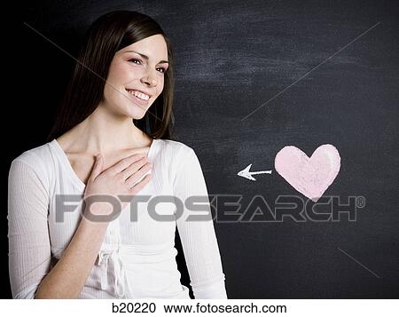 young woman against a chalkboard View Large Photo Image Stock Image - young woman against a chalkboard. Fotosearch