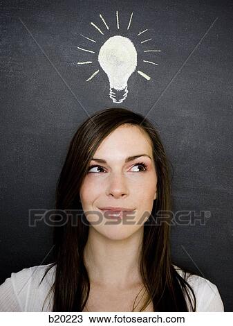 young woman against a chalkboard View Large Photo Image Stock Image - young woman against a chalkboard. Fotosearch
