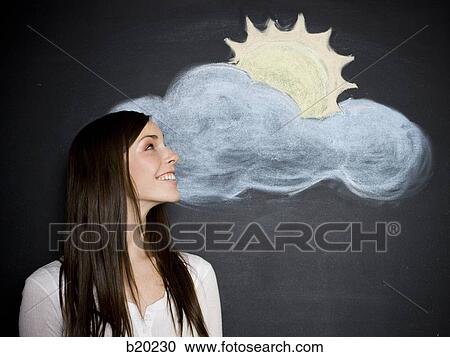 young woman against a chalkboard View Large Photo Image Stock Image - young woman against a chalkboard. Fotosearch