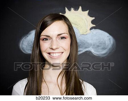 Stock Image - young woman against a chalkboard. Fotosearch