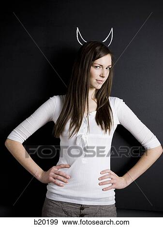 young woman against a chalkboard View Large Photo Image Stock Photo - young woman against a chalkboard. Fotosearch