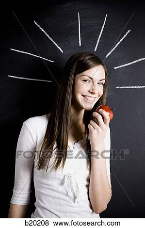 young woman against a chalkboard View Large Photo Image Stock Photo - young woman against a chalkboard. Fotosearch
