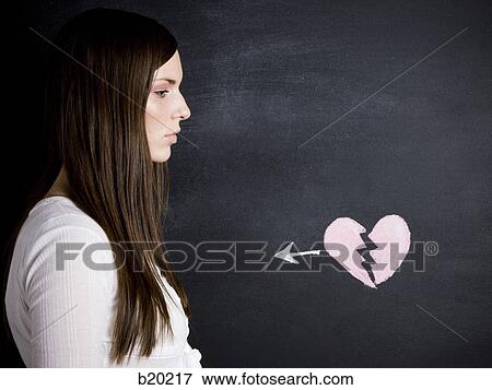 young woman against a chalkboard View Large Photo Image Stock Photo - young woman against a chalkboard. Fotosearch
