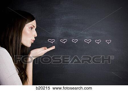 young woman against a chalkboard View Large Photo Image Stock Photography - young woman against a chalkboard. Fotosearch