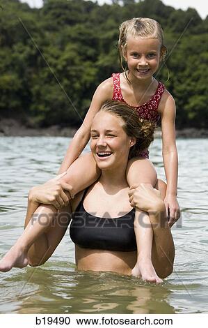 young woman and girl in the water View Large Photo Image Stock Image - young woman and girl in the water. Fotosearch