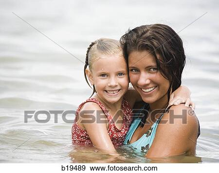 young woman and girl in the water View Large Photo Image Stock Photo - young woman and girl in the water. Fotosearch