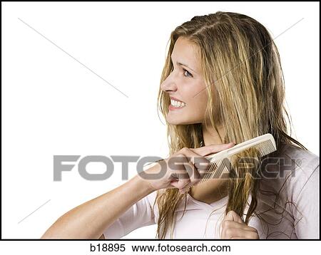 Young woman combing hair. View Large Photo Image Stock Photography - Young woman combing hair.. Fotosearch