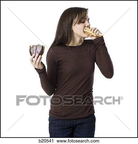 young woman eating junk food View Large Photo Image Stock Image - young woman eating junk food. Fotosearch