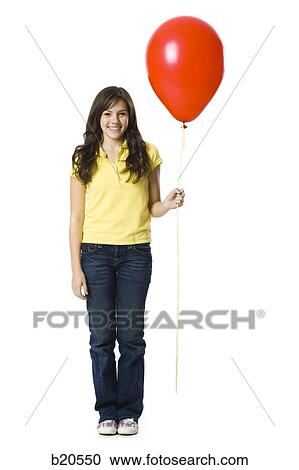 young woman holding a red balloon View Large Photo Image Stock Image - young woman holding a red balloon. Fotosearch