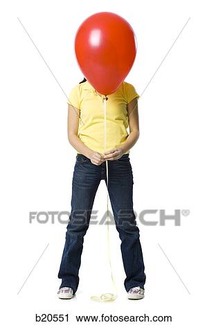 young woman holding a red balloon View Large Photo Image Stock Image - young woman holding a red balloon. Fotosearch