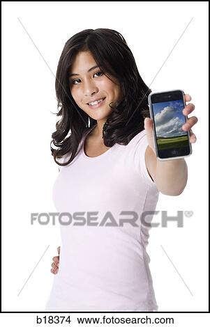 Young woman holding an iphone. View Large Photo Image Picture - Young woman holding an iphone.. Fotosearch