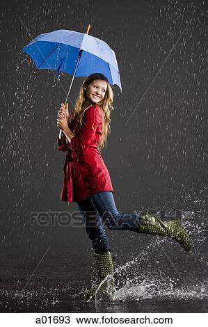 young woman holding an umbrella. View Large Photo Image Stock Image - young woman holding an umbrella.. Fotosearch