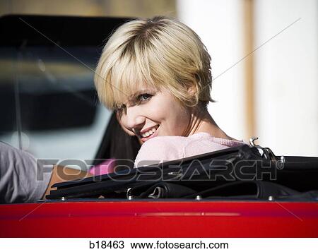 Young woman in a convertible car. View Large Photo Image Stock Image - Young woman in a convertible car.. Fotosearch