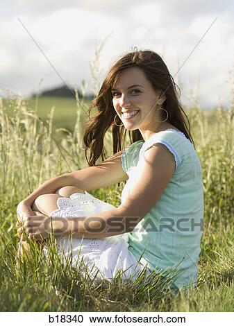 Stock Image - Young woman in a field.. Fotosearch