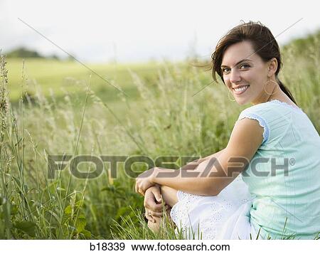 Stock Photo - Young woman in a field.. Fotosearch