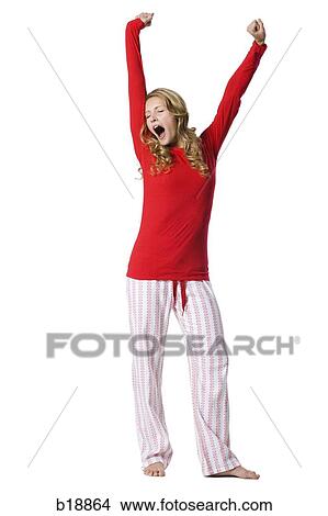 young woman in pajamas yawning. View Large Photo Image Picture - young woman in pajamas yawning.. Fotosearch