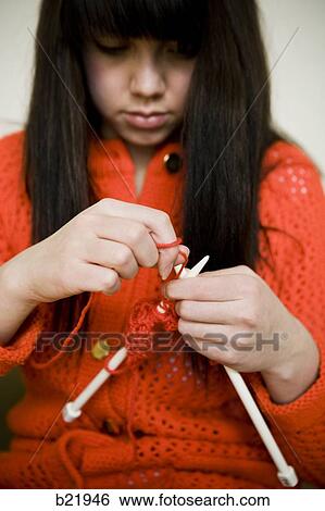 Stock Photograph - young woman knitting. Fotosearch