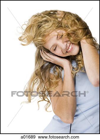 Stock Photo - young woman listening to earphones.. Fotosearch
